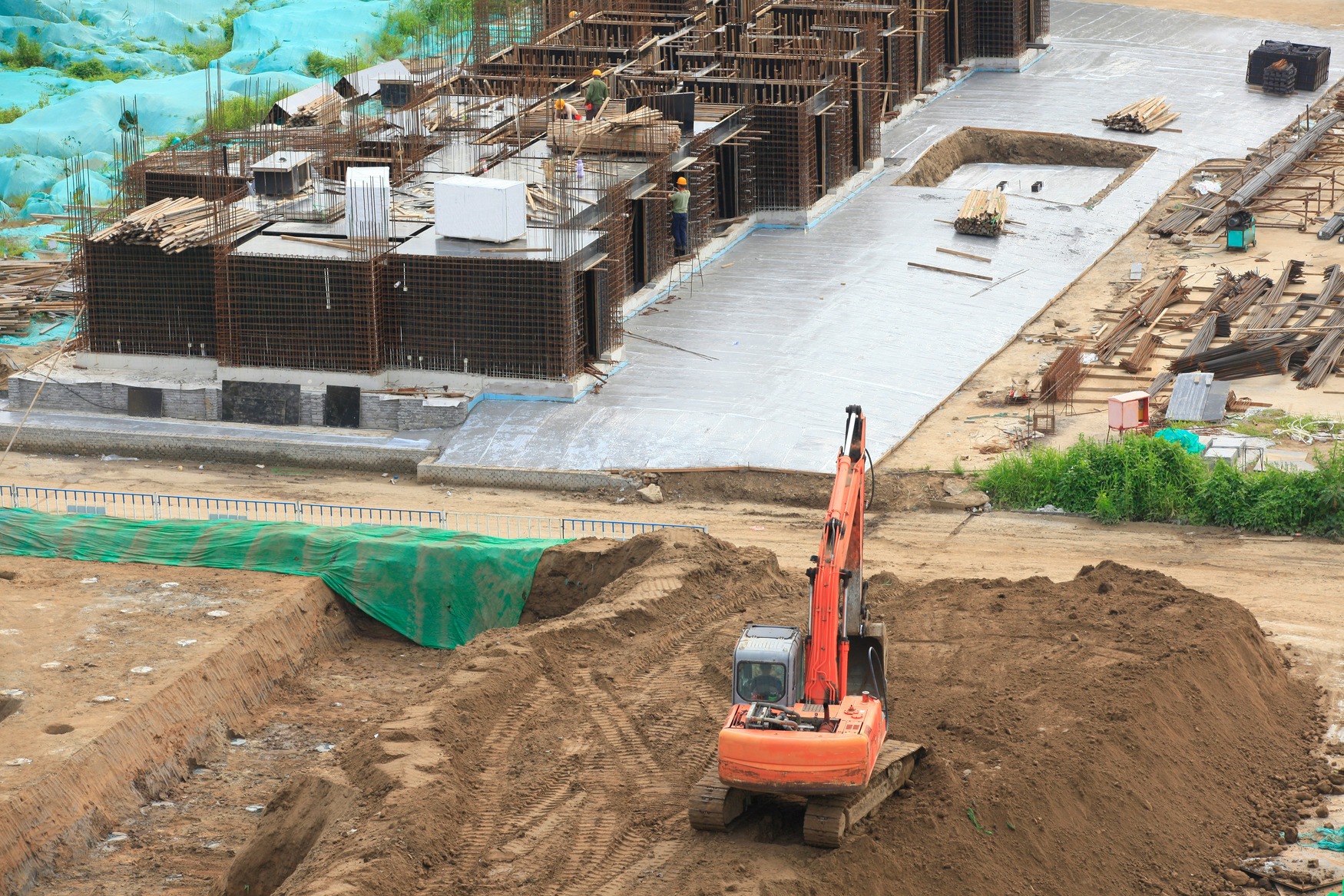 Aerial view of construction site with half-finished structures and large machinery