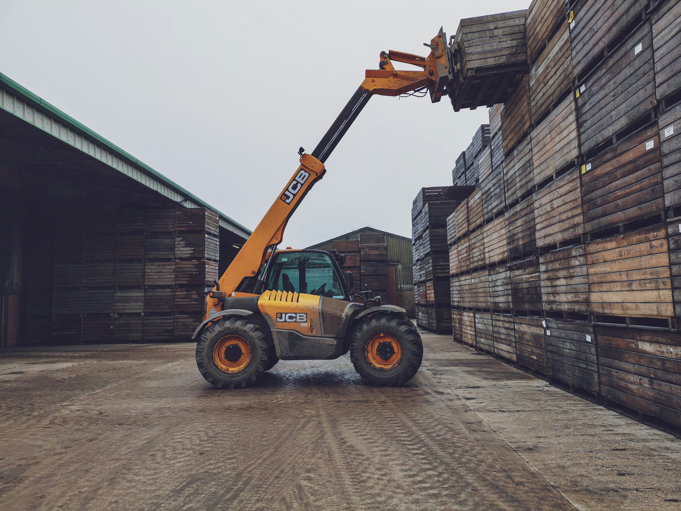 Telehandler on site carrying box